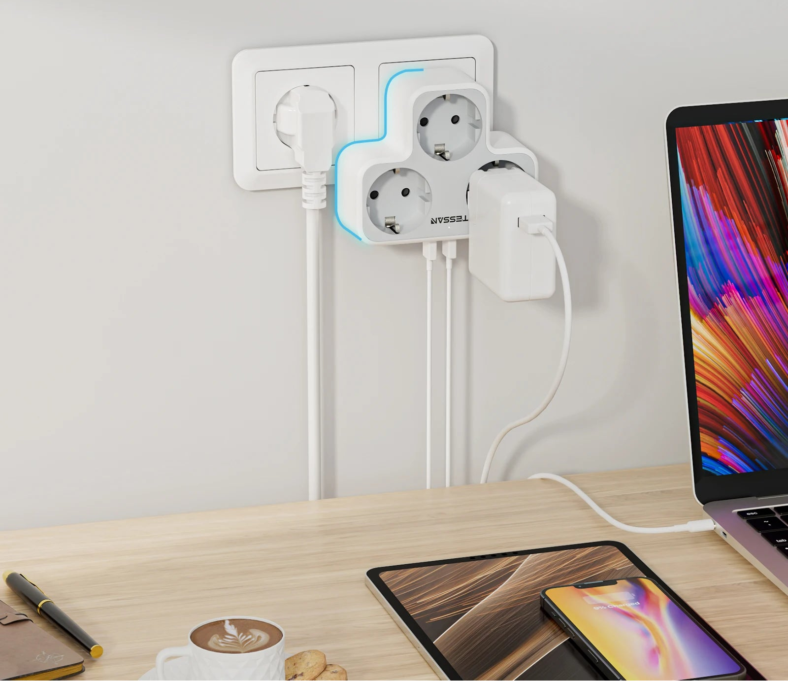 Multiple wall sockets on a desk with electronic devices, emphasizing non-blocking design.